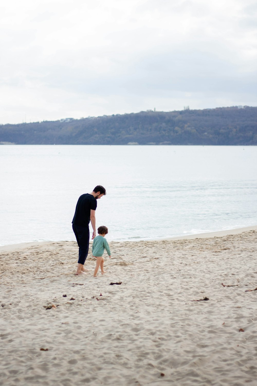 a man and a small child on a beach