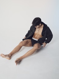 a man sitting on the ground with his legs crossed
