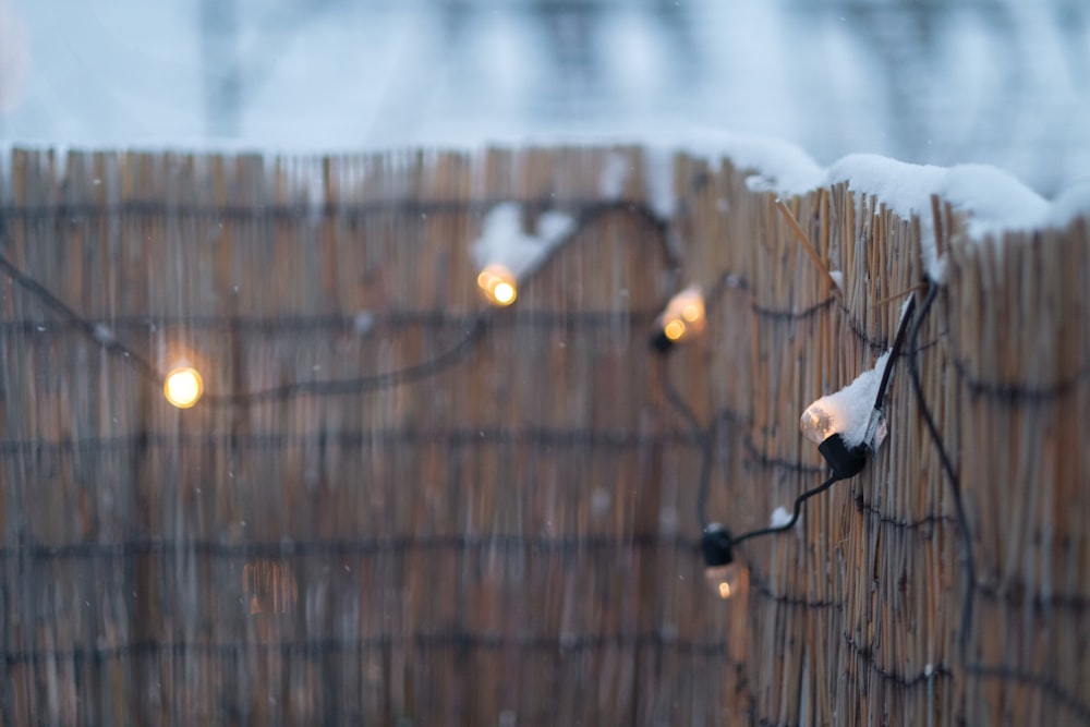 a wooden fence with some lights on it