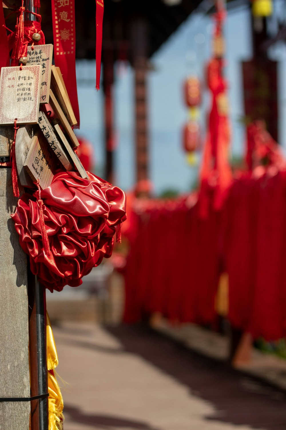 a bunch of red and yellow items hanging from a pole