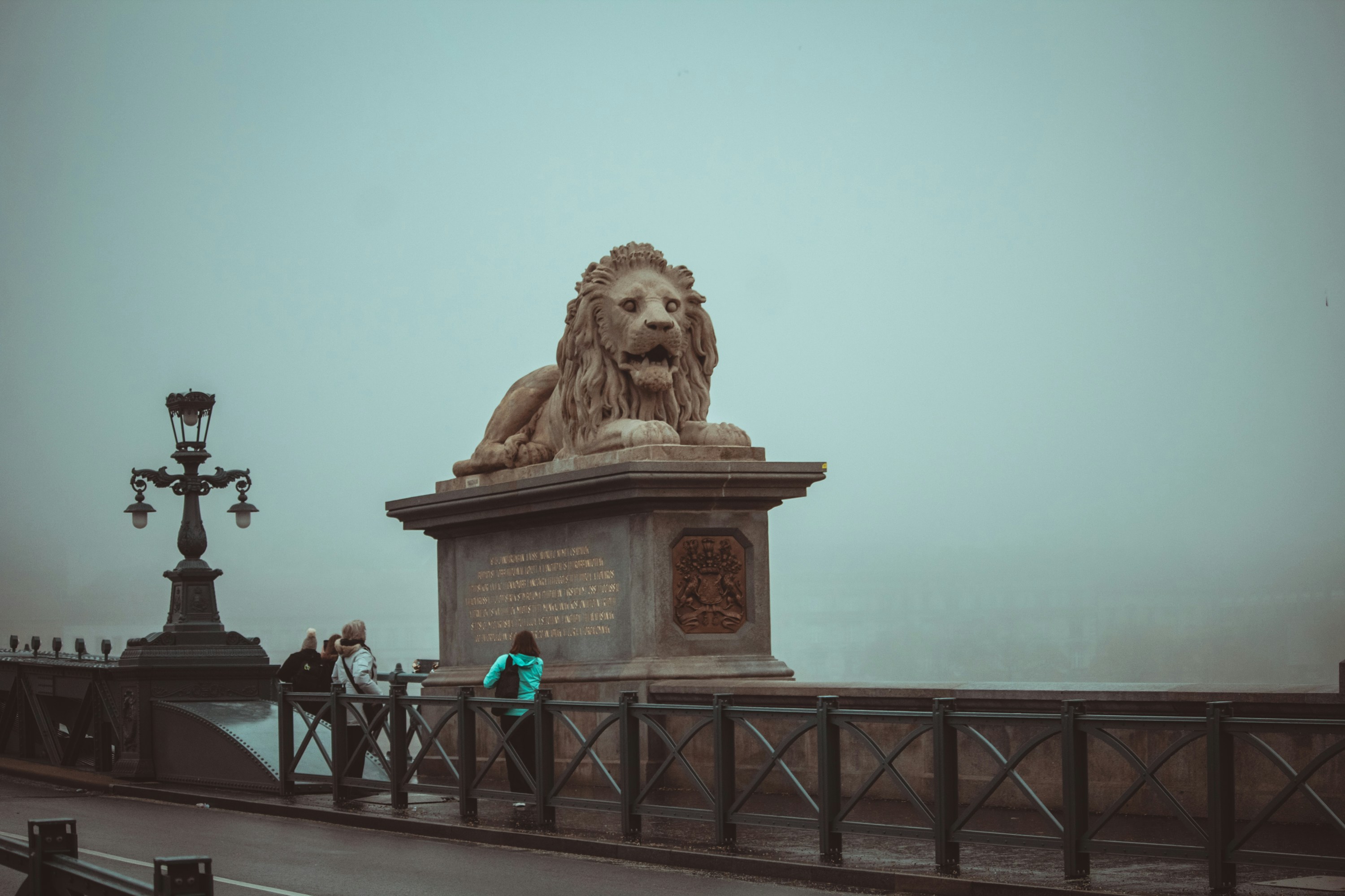 a statue of a lion on a bridge