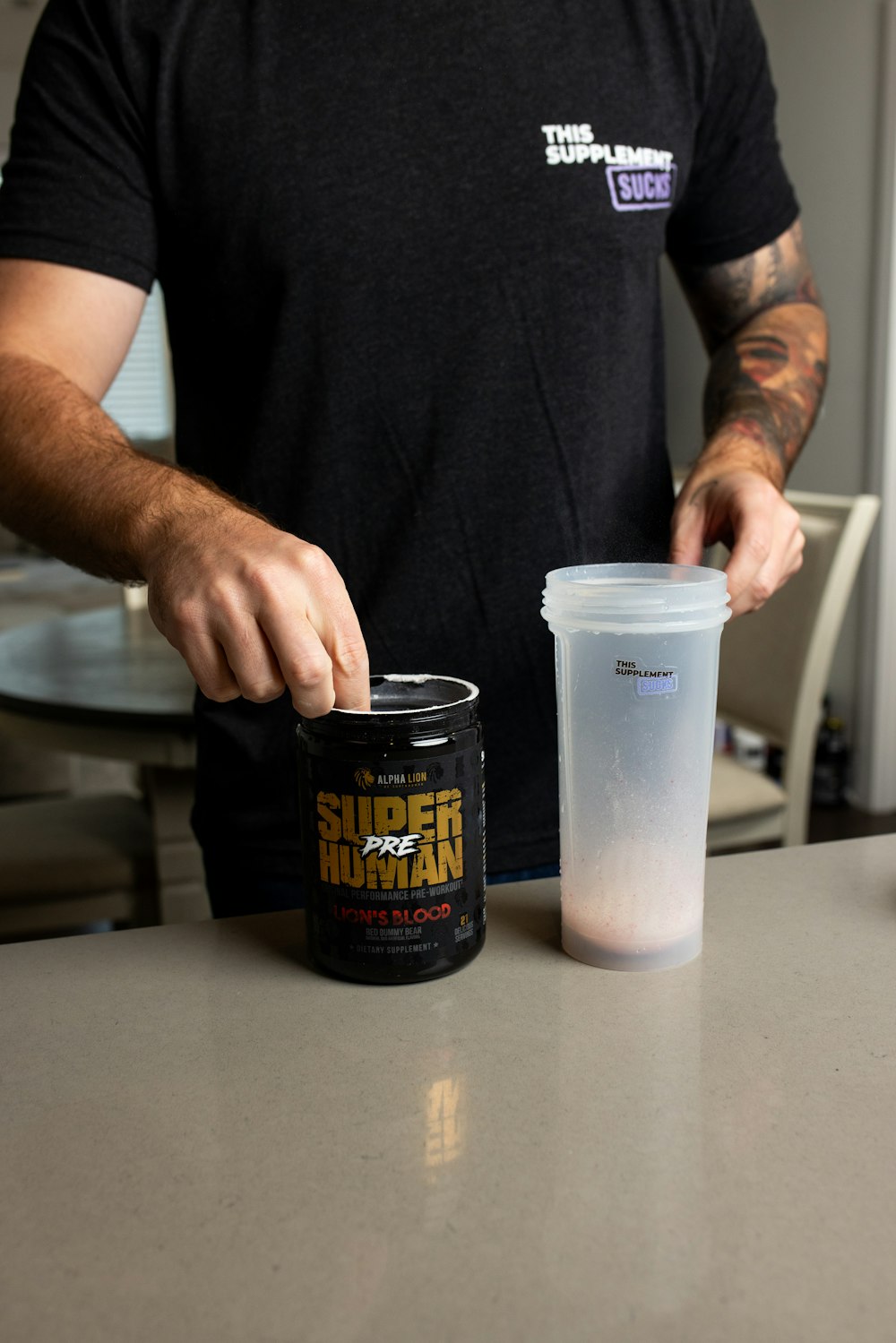 a man holding a cup of coffee next to a plastic cup