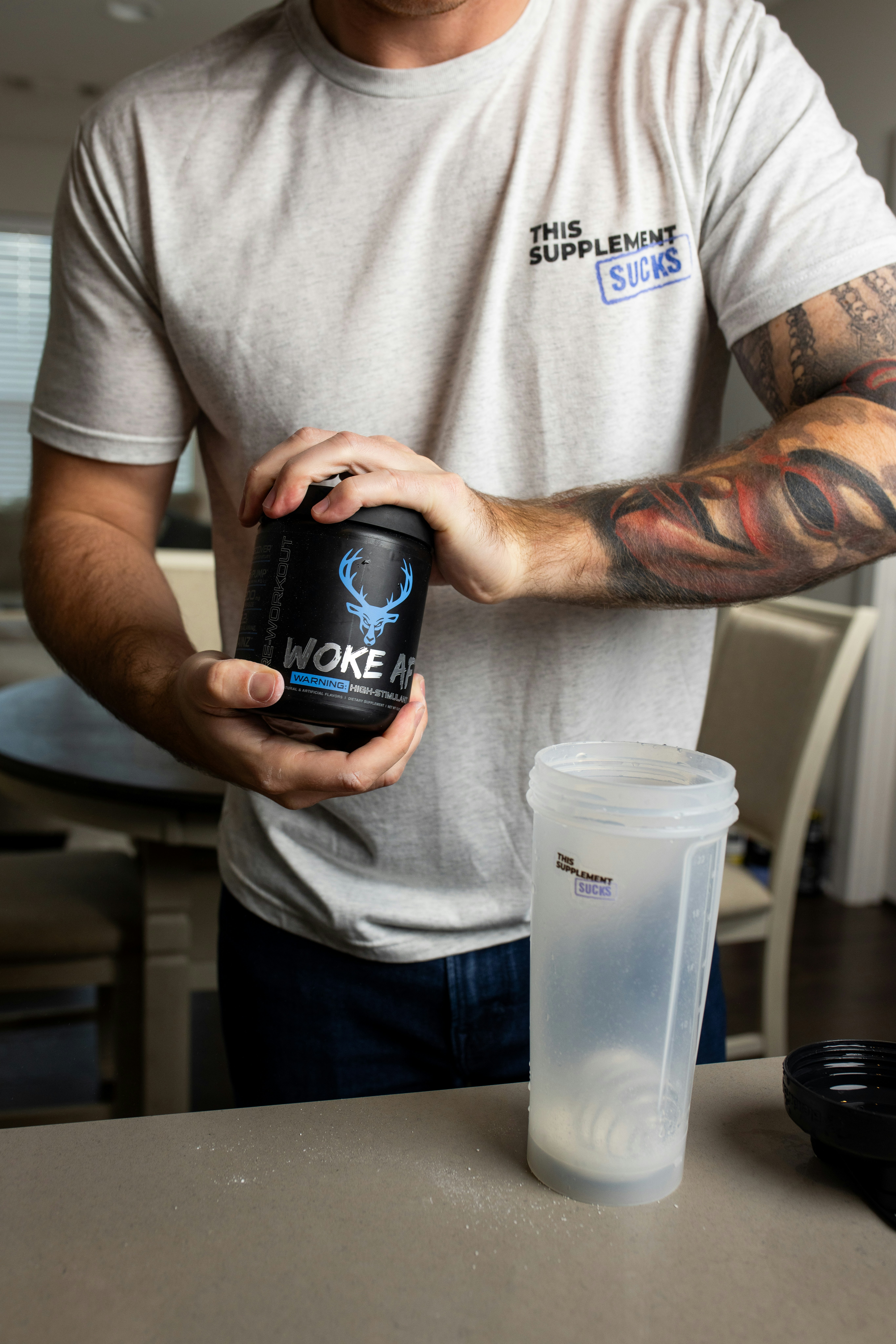 a man holding a can of smoke on top of a table