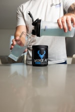 a man pouring a drink into a glass