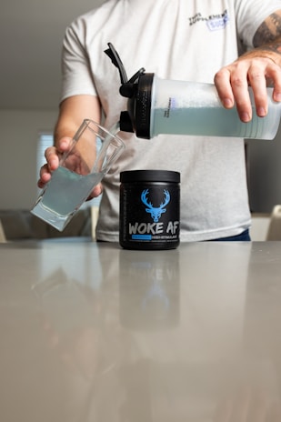 a man pouring a drink into a glass