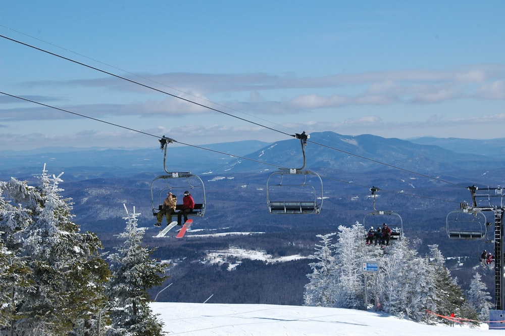 a couple of people riding a ski lift