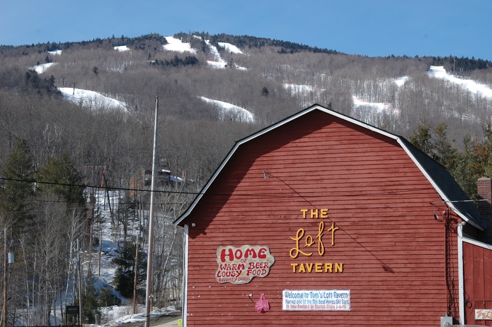 a red barn with a mountain in the background