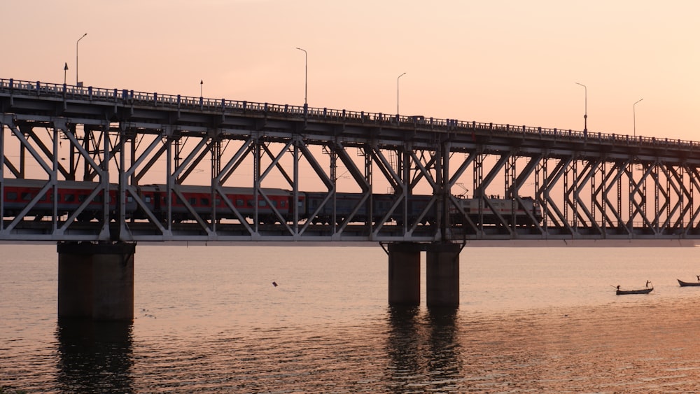 a train crossing a bridge over a body of water