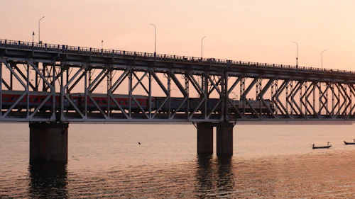 River bridge lit at dusk, similar to the Tapi riverfront in Surat