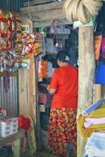 A friendly Redwood Broking representative assisting a local kirana store owner with product selection.