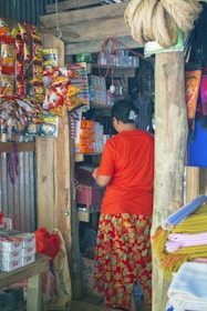 A friendly Redwood Broking representative assisting a local kirana store owner with product selection.