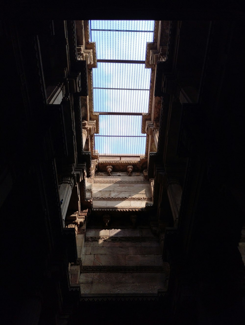 a stairway leading up to a skylight in a building