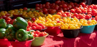 Brightly colored carrots, tomatoes, and cucumbers displayed on a wooden table.