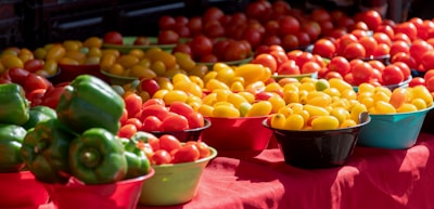 Brightly colored carrots, tomatoes, and cucumbers displayed on a wooden table.