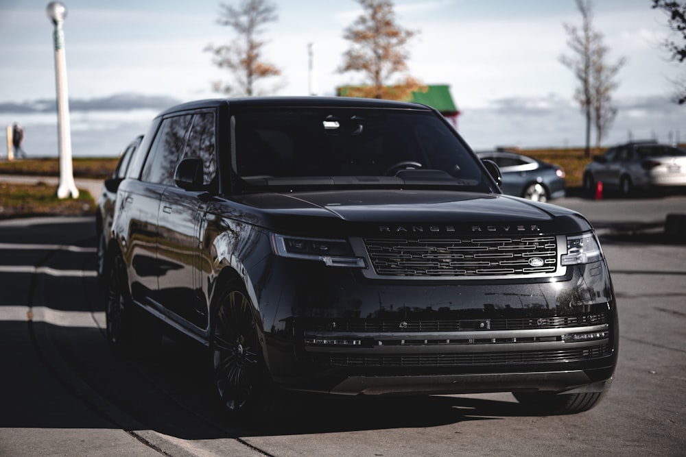 a black range rover parked in a parking lot