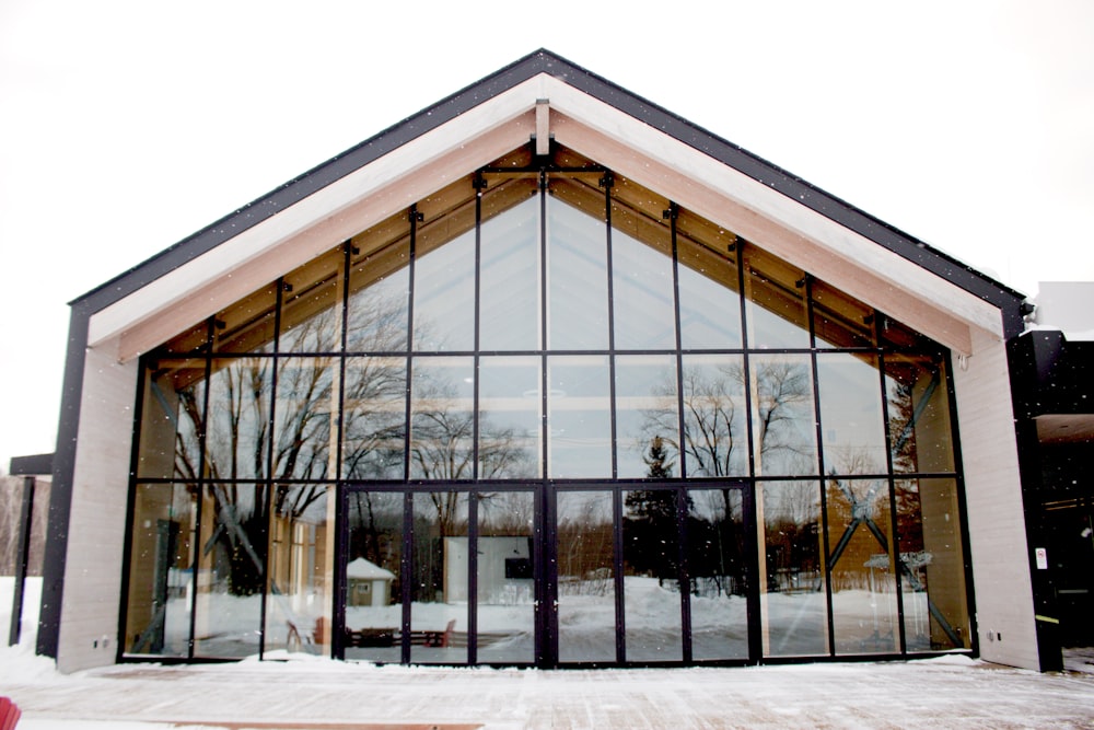 a building with a lot of windows and snow on the ground