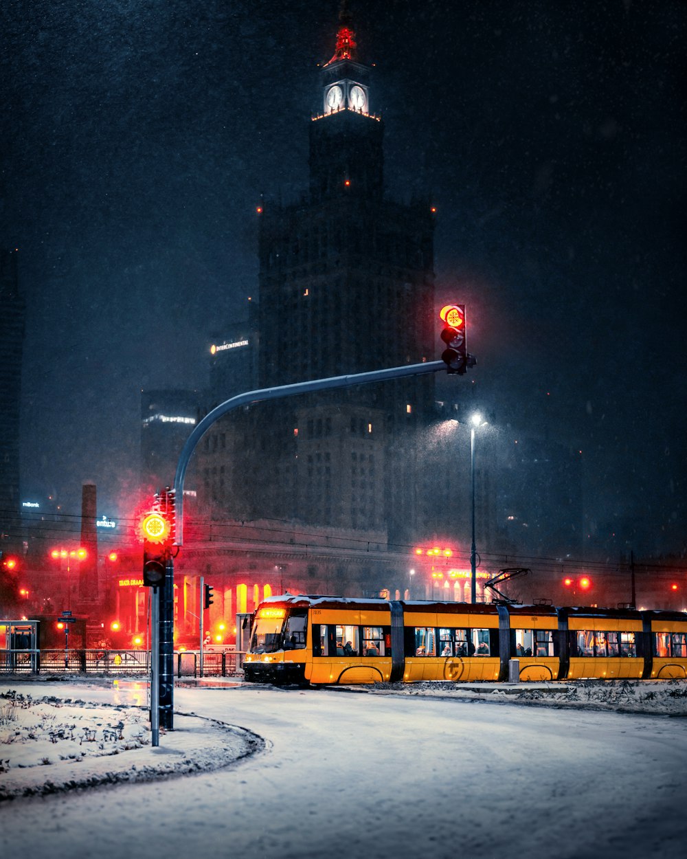 a city street at night with snow on the ground