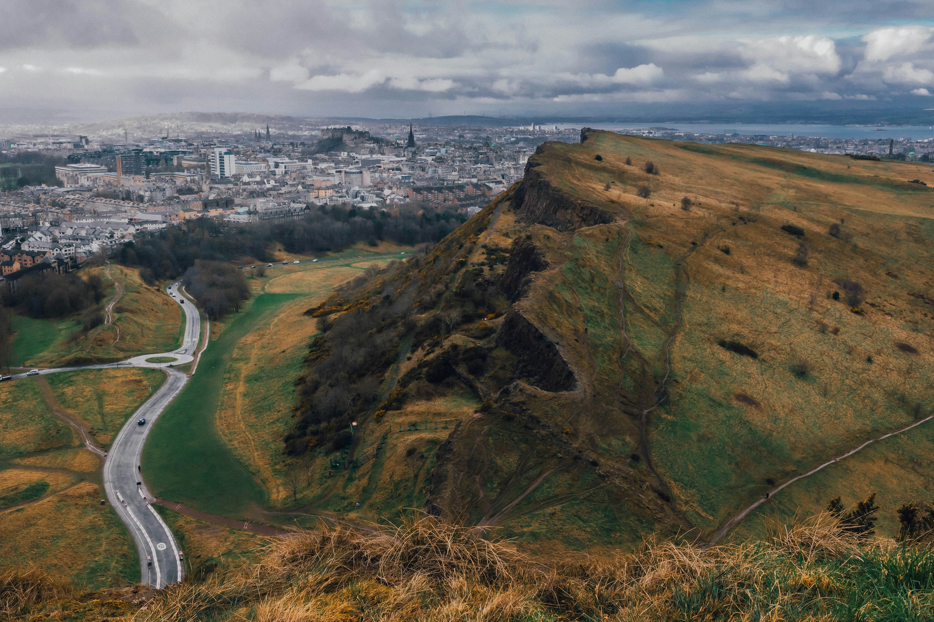 a view of a city from the top of a hill, Panoramic view of Edinburgh from Holyrood Park