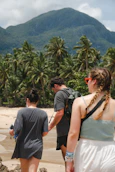 a group of people walking along a sandy beach