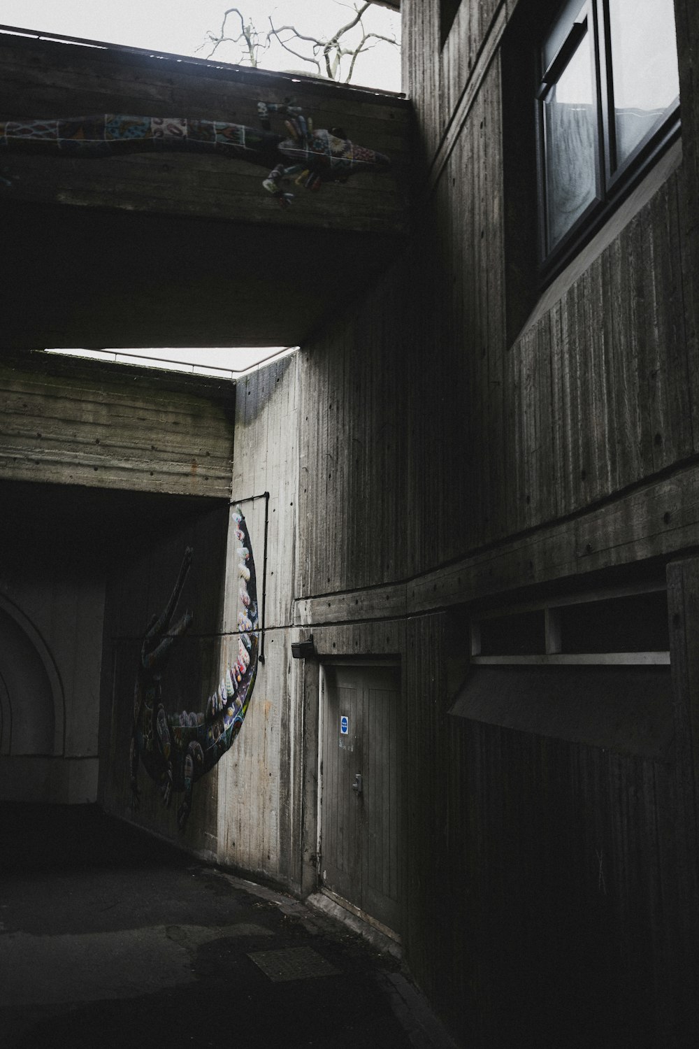 a dark hallway with a painting on the wall