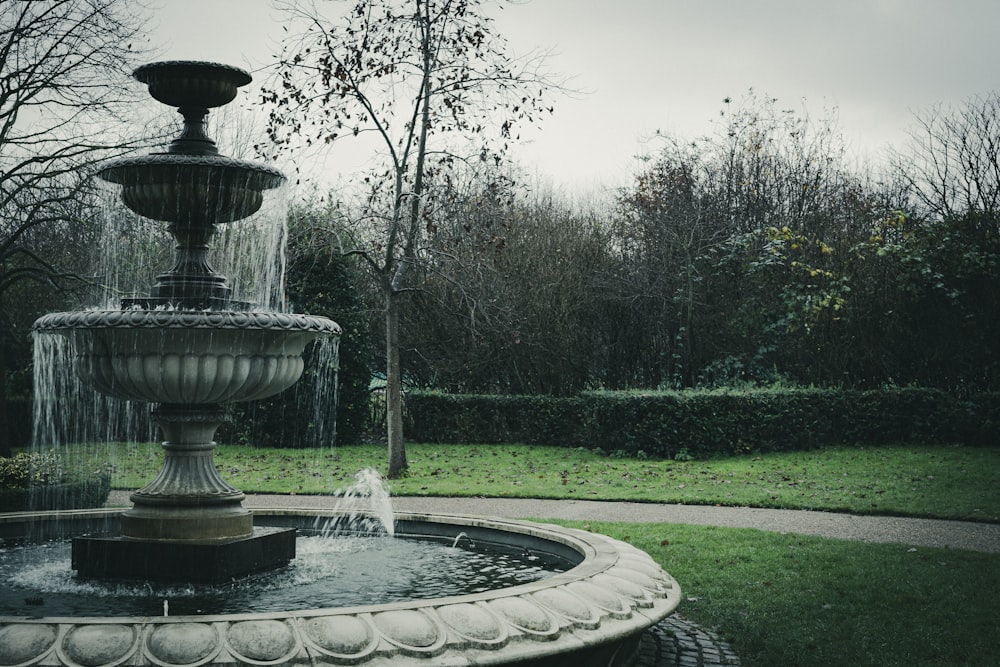 a water fountain in the middle of a park