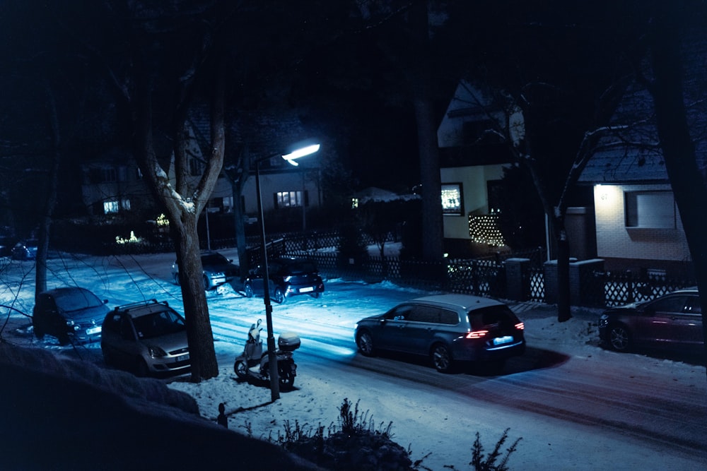 a car parked on a snowy street at night