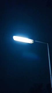 a street light is lit up in the dark