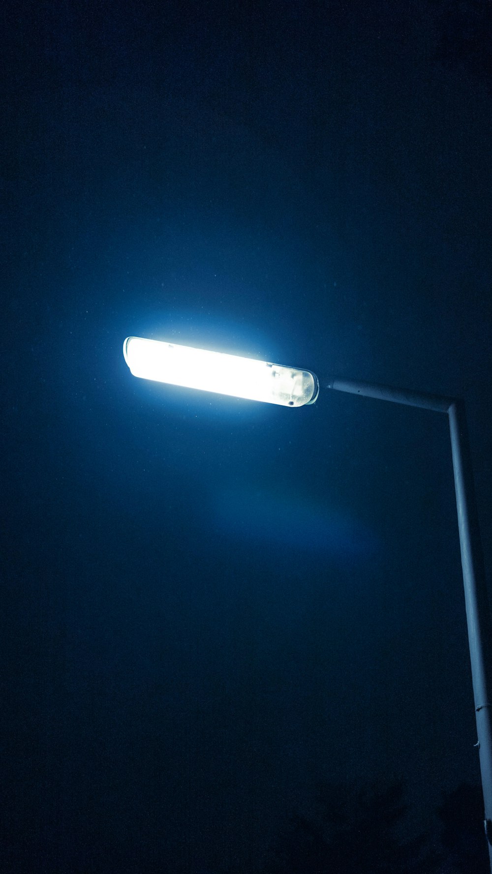 a street light is lit up in the dark