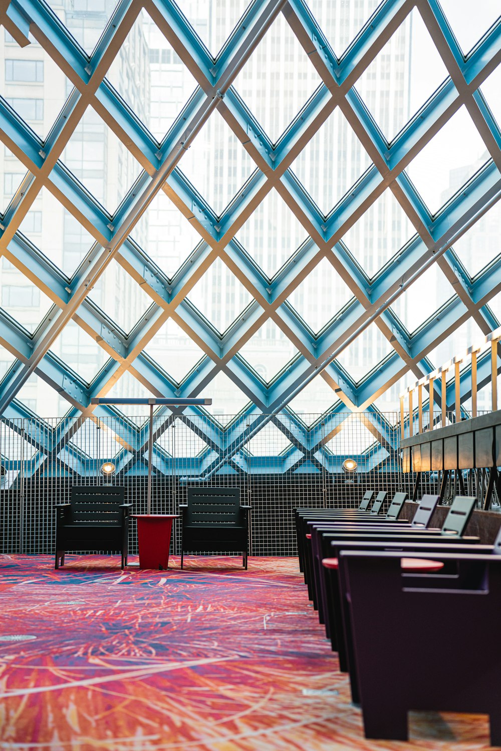 rows of chairs in a large room with a skylight