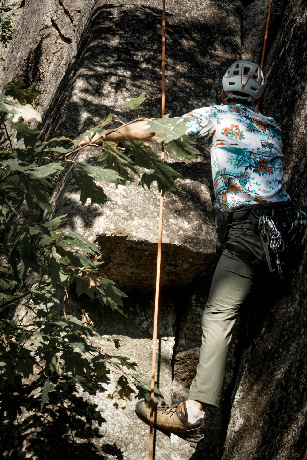 a man climbing up the side of a mountain