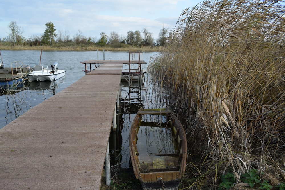 a boat is docked at the end of a dock