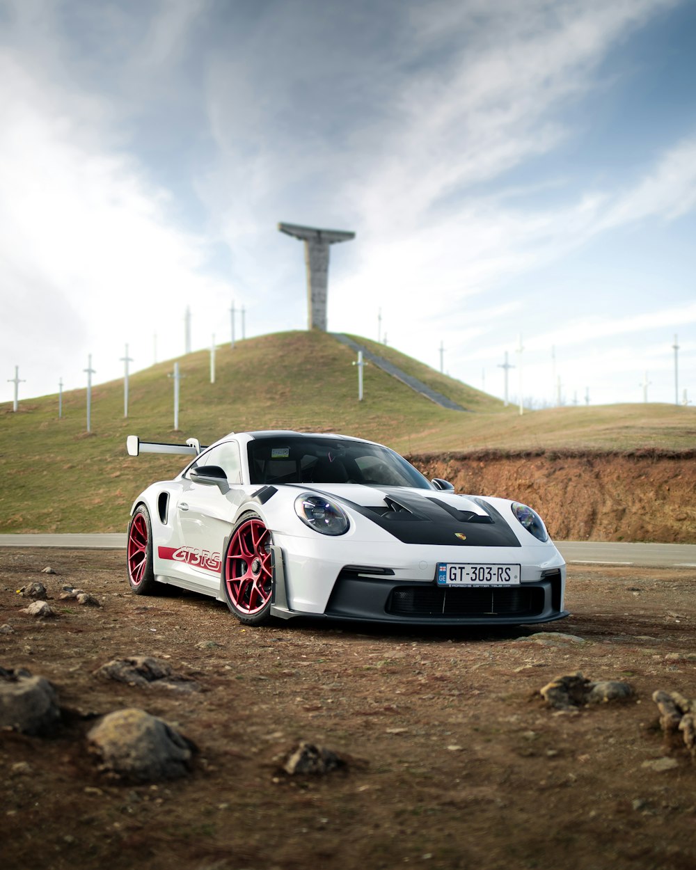 a white sports car parked on the side of a road