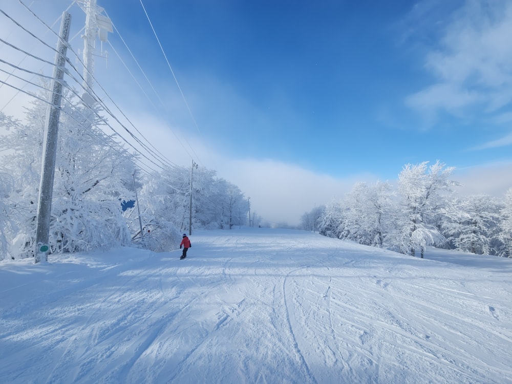 a person skiing down a snow covered ski slope