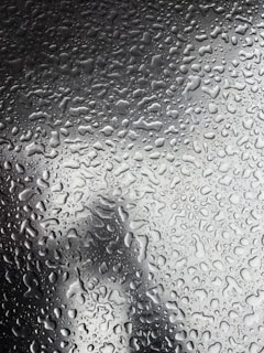 A close-up of water droplets on a smooth surface.