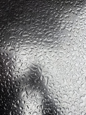 A close-up of water droplets on a smooth surface.