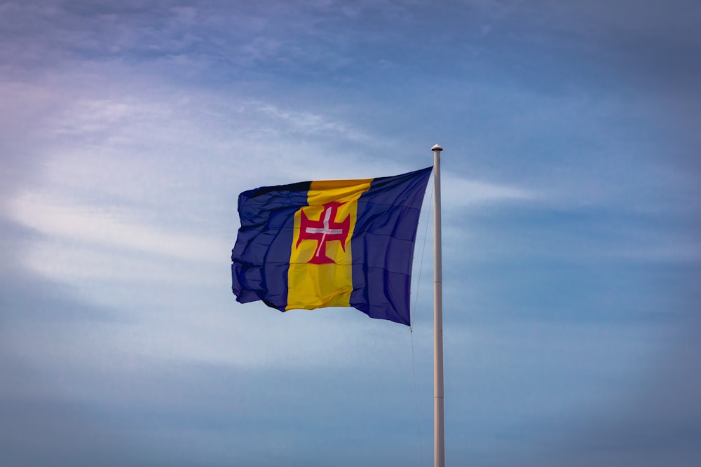 a blue and yellow flag flying in the wind