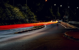 a long exposure photo of a street at night