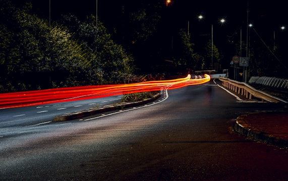 a long exposure photo of a street at night