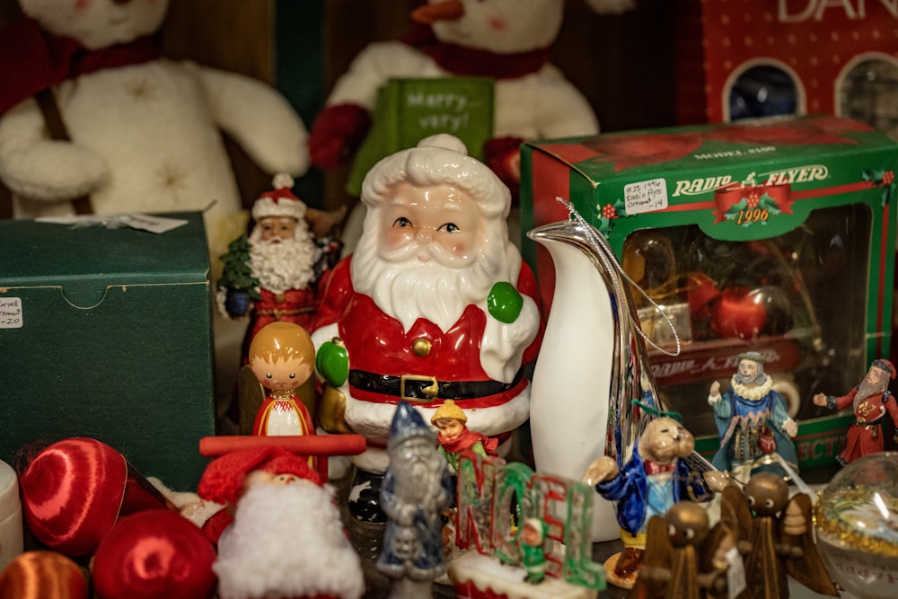 a collection of christmas ornaments and figurines on a table