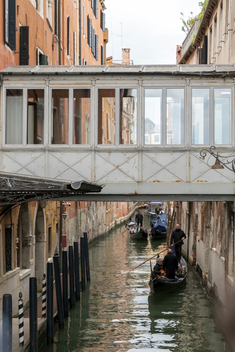 a bridge over a canal with two gondolas in it