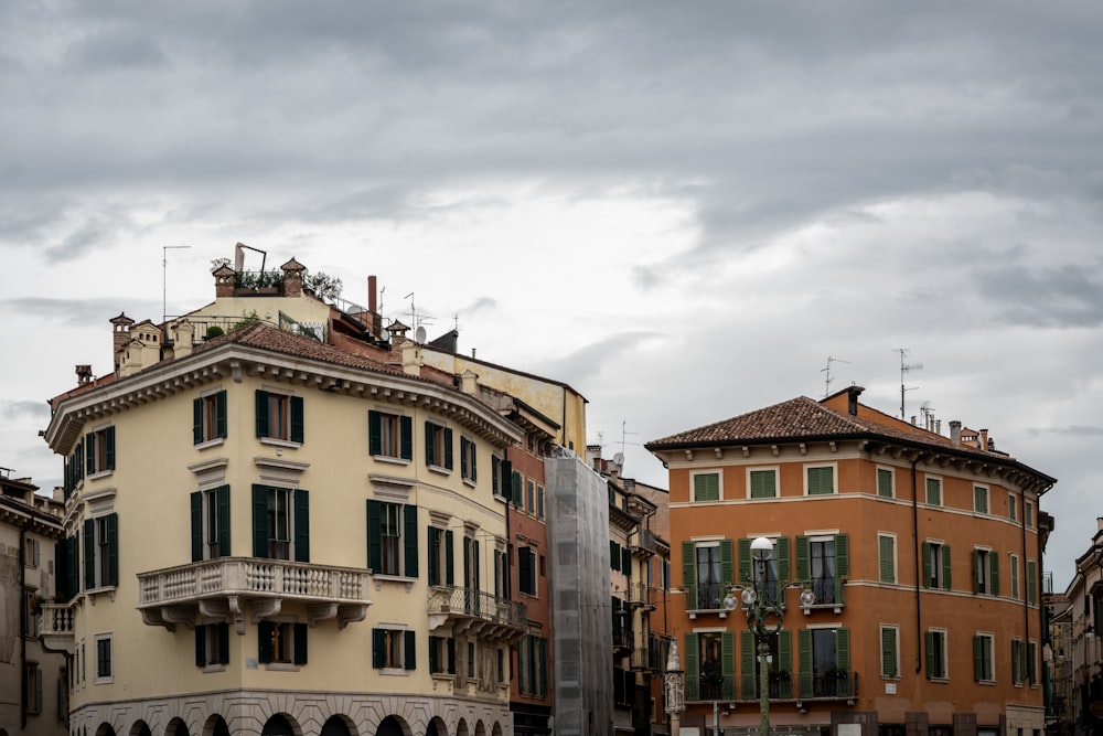 a row of buildings with a cloudy sky in the background