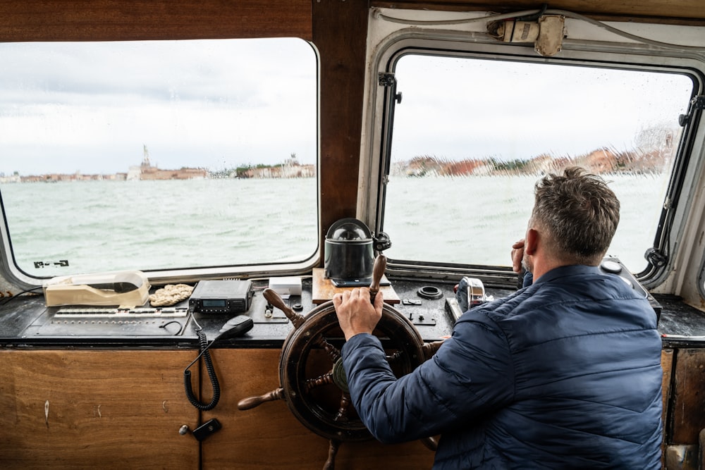 a man driving a boat on a body of water