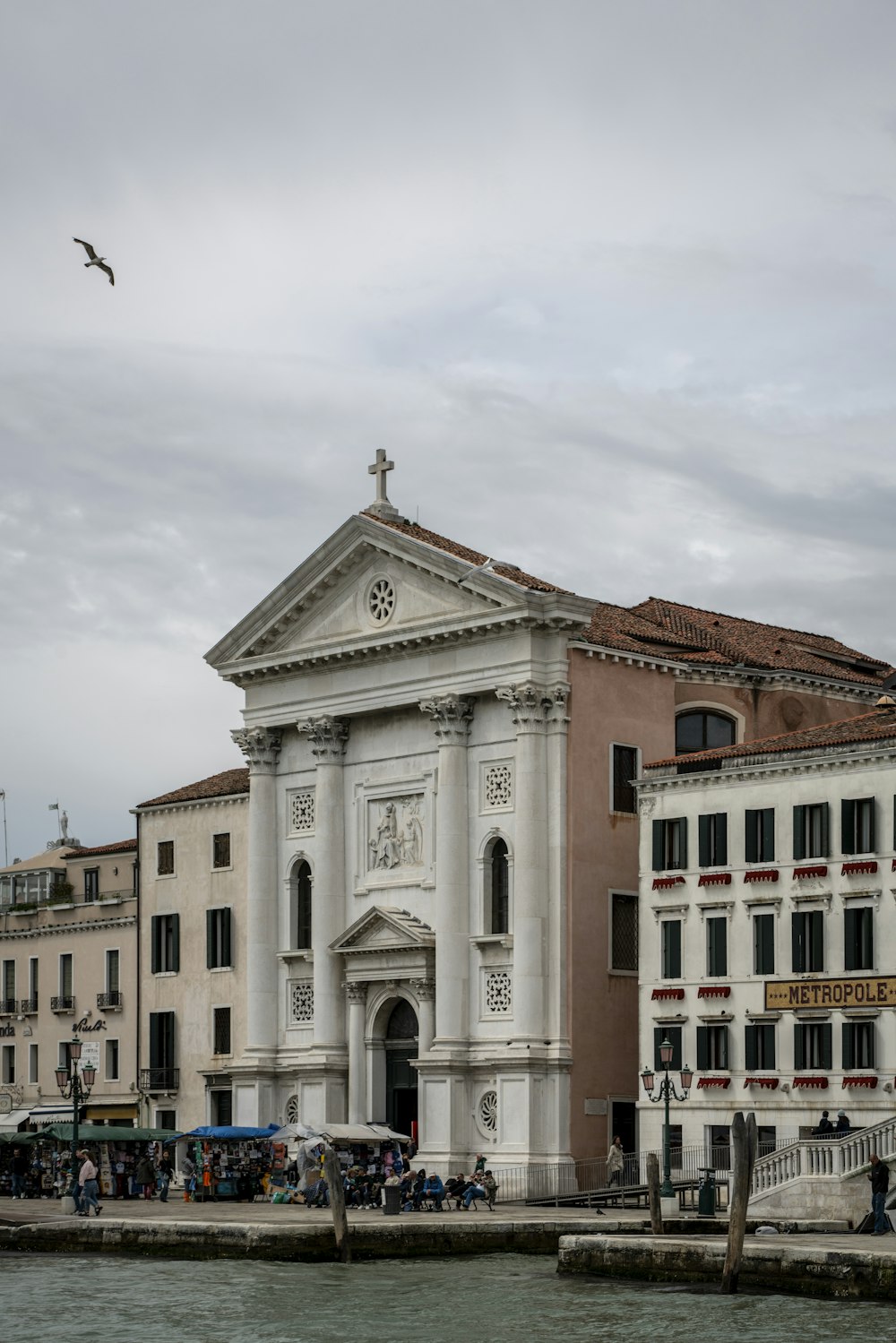 a large white building sitting next to a body of water