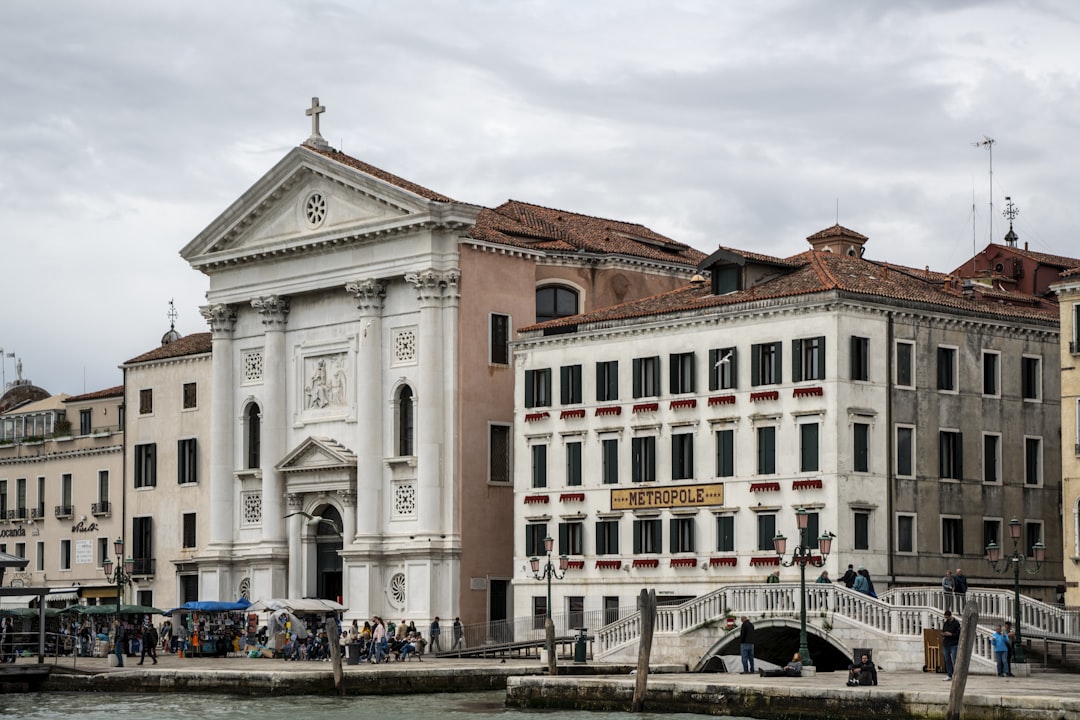 a group of people walking on a bridge over a body of water, Venice city