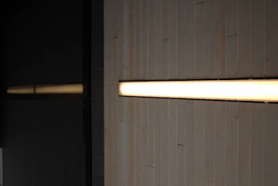 Cbrn air filtration unit installed seamlessly into a wall, glowing softly in ambient light.