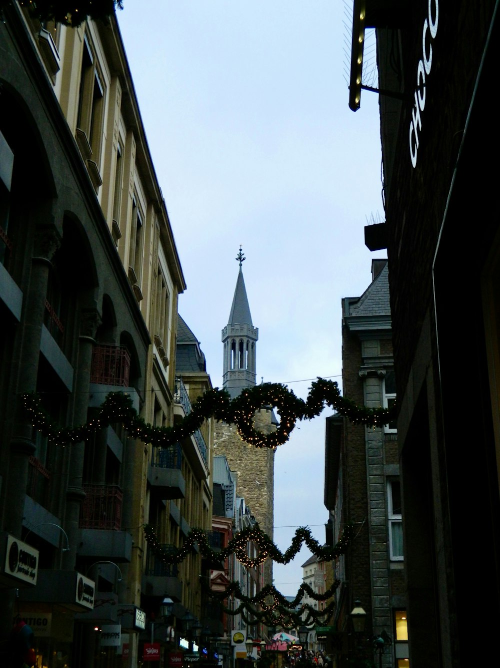 a city street with a clock tower in the background