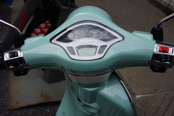 Close-up of the scooter’s digital dashboard glowing with green accents in a minimalist style.