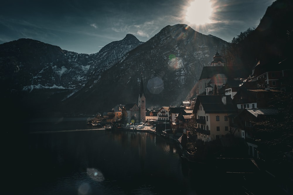 the sun shines brightly over a small town on a lake