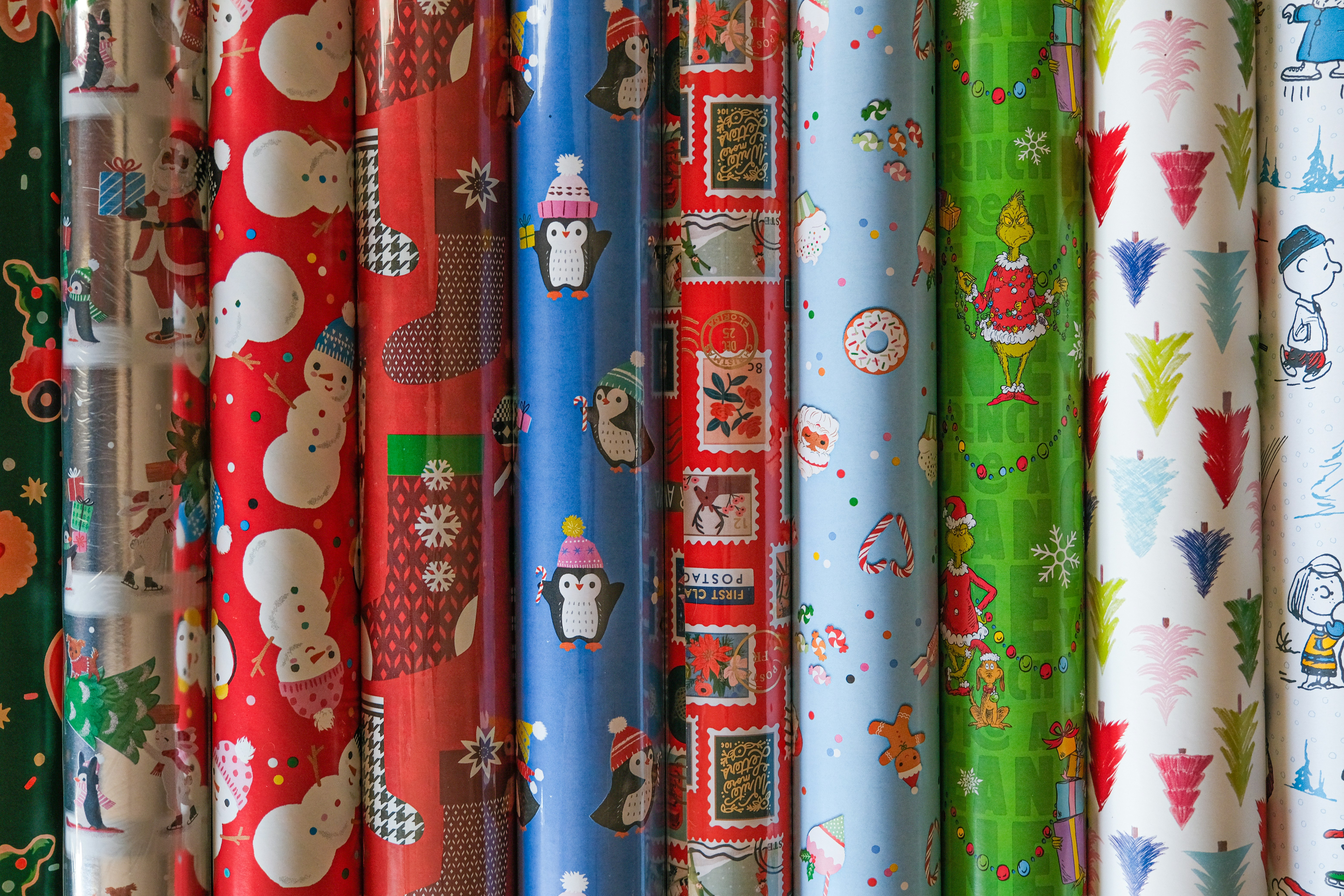 A bunch of different colored wrapping paper on a rack photo – Free ...