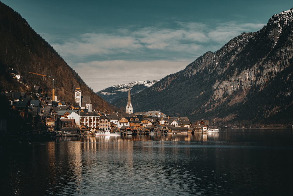 a village on a lake surrounded by mountains